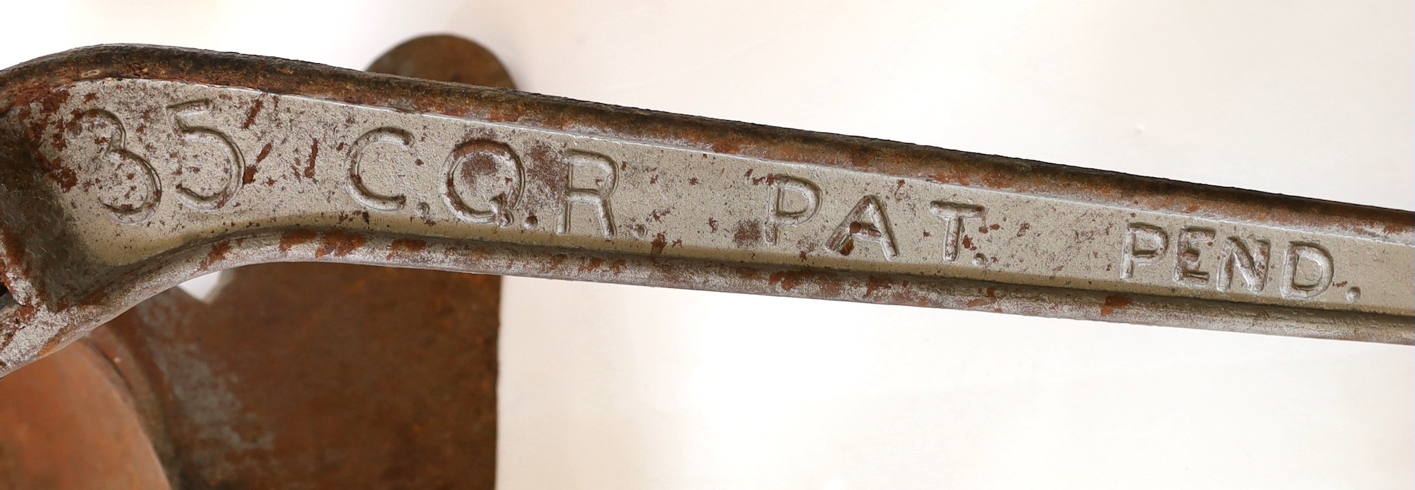 A silver painted cast iron hinged plough anchor, stamped 35’ C.Q.R. pat.pend, 102cm